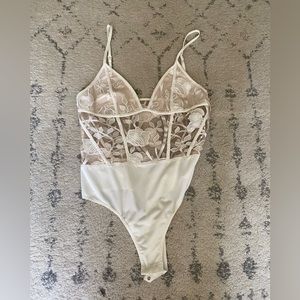 White lacey floral bodysuit with mesh-like material